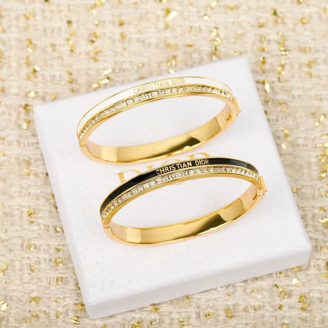 Dior CD New Night Code Bangle bracelet Gold-tone metal with clear channel-set crystals available with white or black enamel accent M