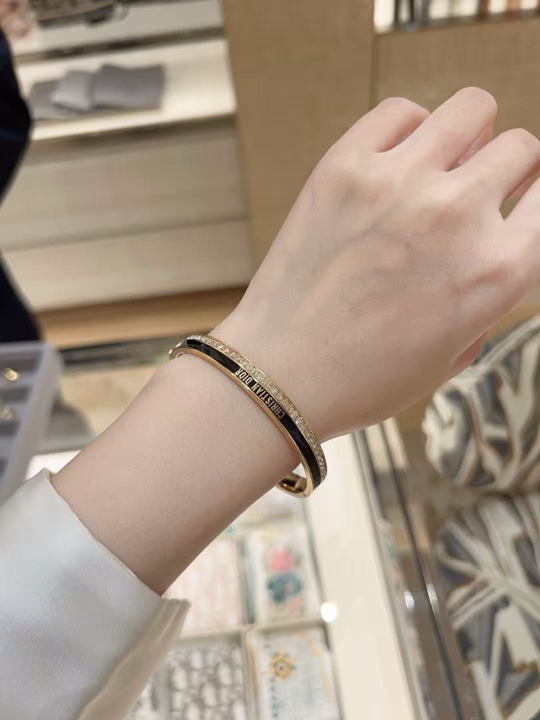 Dior CD New Night Code Bangle bracelet Gold-tone metal with clear channel-set crystals available with white or black enamel accent M