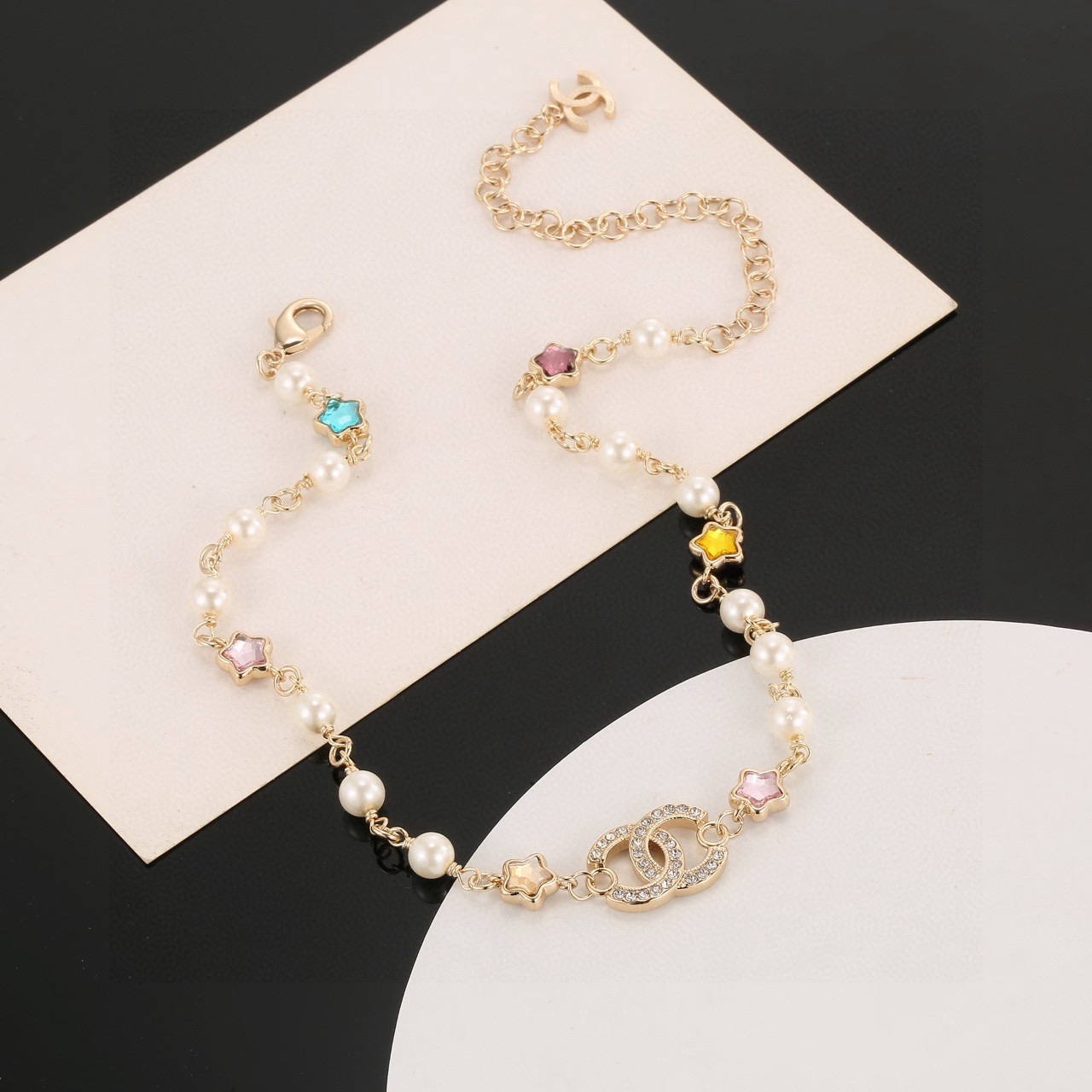 Chanel CC Logo Multicolor Star Pearl Bracelet bracelet Gold-tone metal white faux pearls clear crystals multicolor star stones blue pink purple yellow champagne 18cm with 5cm extension chain