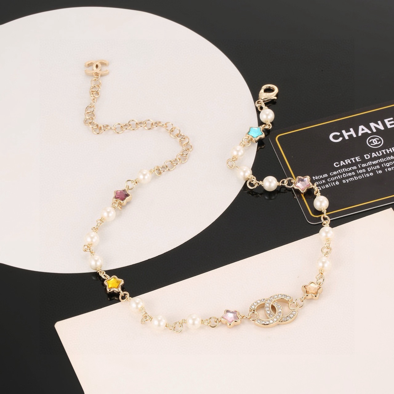Chanel CC Logo Multicolor Star Pearl Bracelet bracelet Gold-tone metal white faux pearls clear crystals multicolor star stones blue pink purple yellow champagne 18cm with 5cm extension chain
