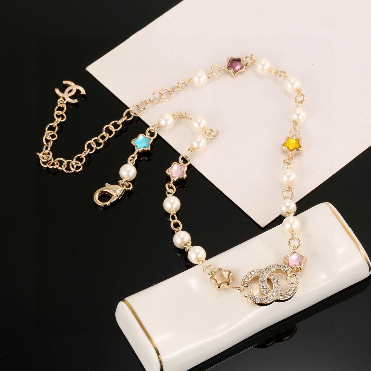 Chanel CC Logo Multicolor Star Pearl Bracelet bracelet Gold-tone metal white faux pearls clear crystals multicolor star stones blue pink purple yellow champagne 18cm with 5cm extension chain