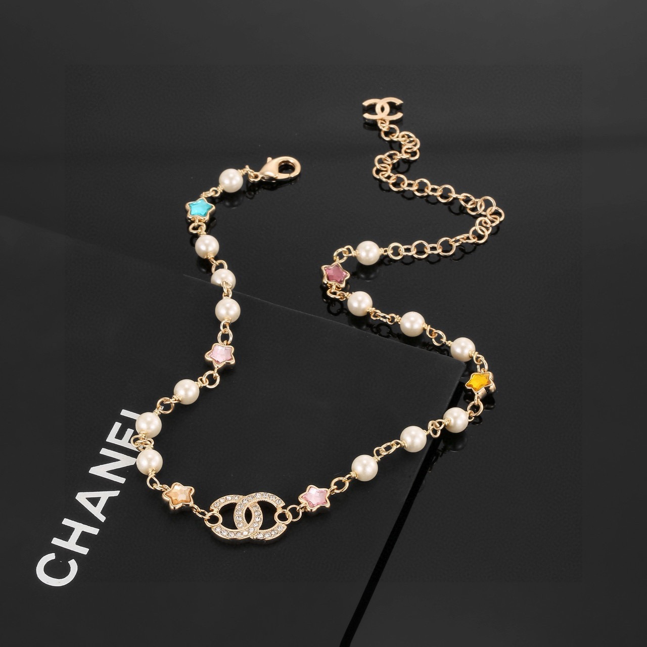 Chanel CC Logo Multicolor Star Pearl Bracelet bracelet Gold-tone metal white faux pearls clear crystals multicolor star stones blue pink purple yellow champagne 18cm with 5cm extension chain