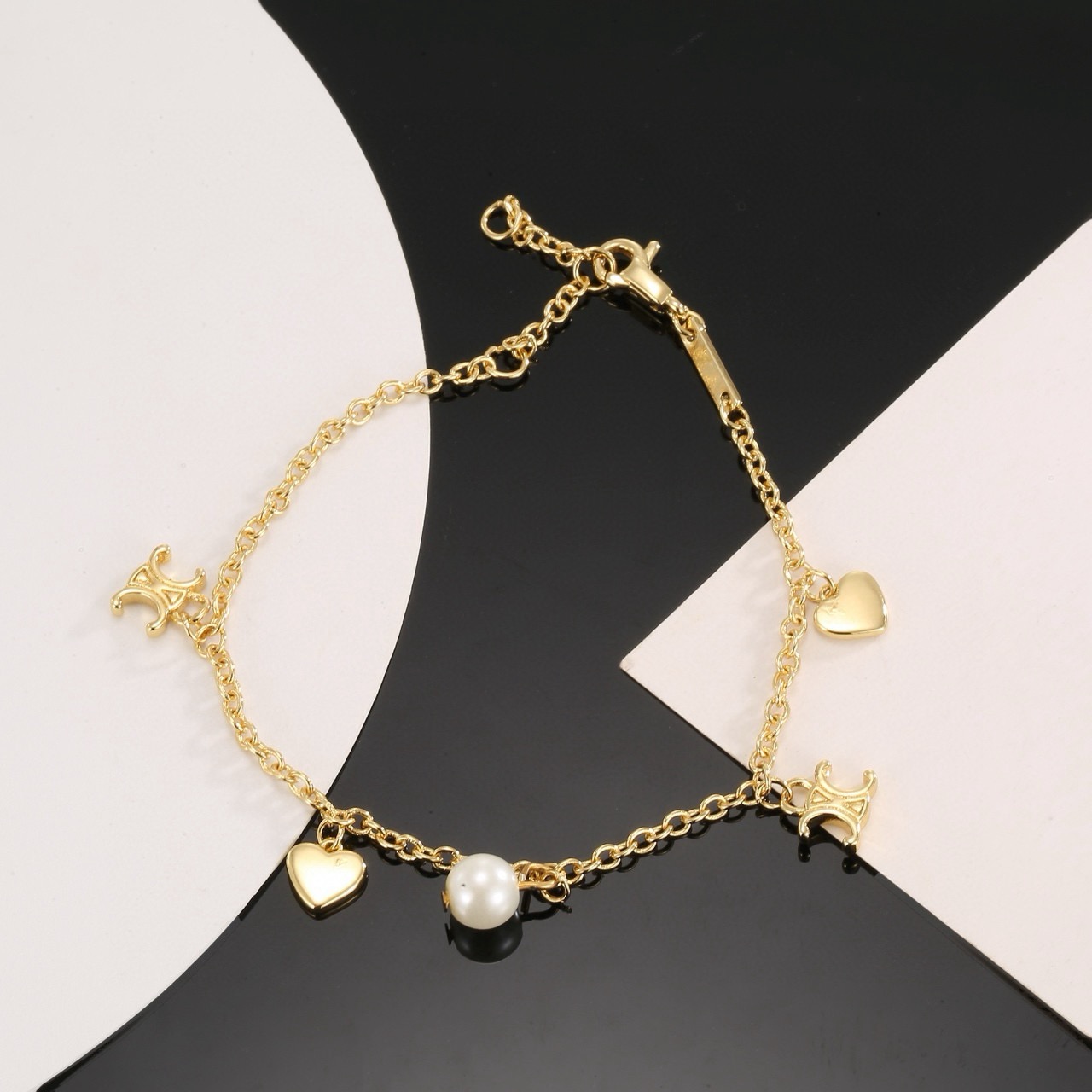 Celine Triomphe Heart Pearl Charm Bracelet bracelet gold-tone metal with white faux pearl 18cm with 3cm extender