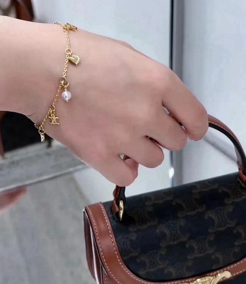 Celine Triomphe Heart Pearl Charm Bracelet bracelet gold-tone metal with white faux pearl 18cm with 3cm extender