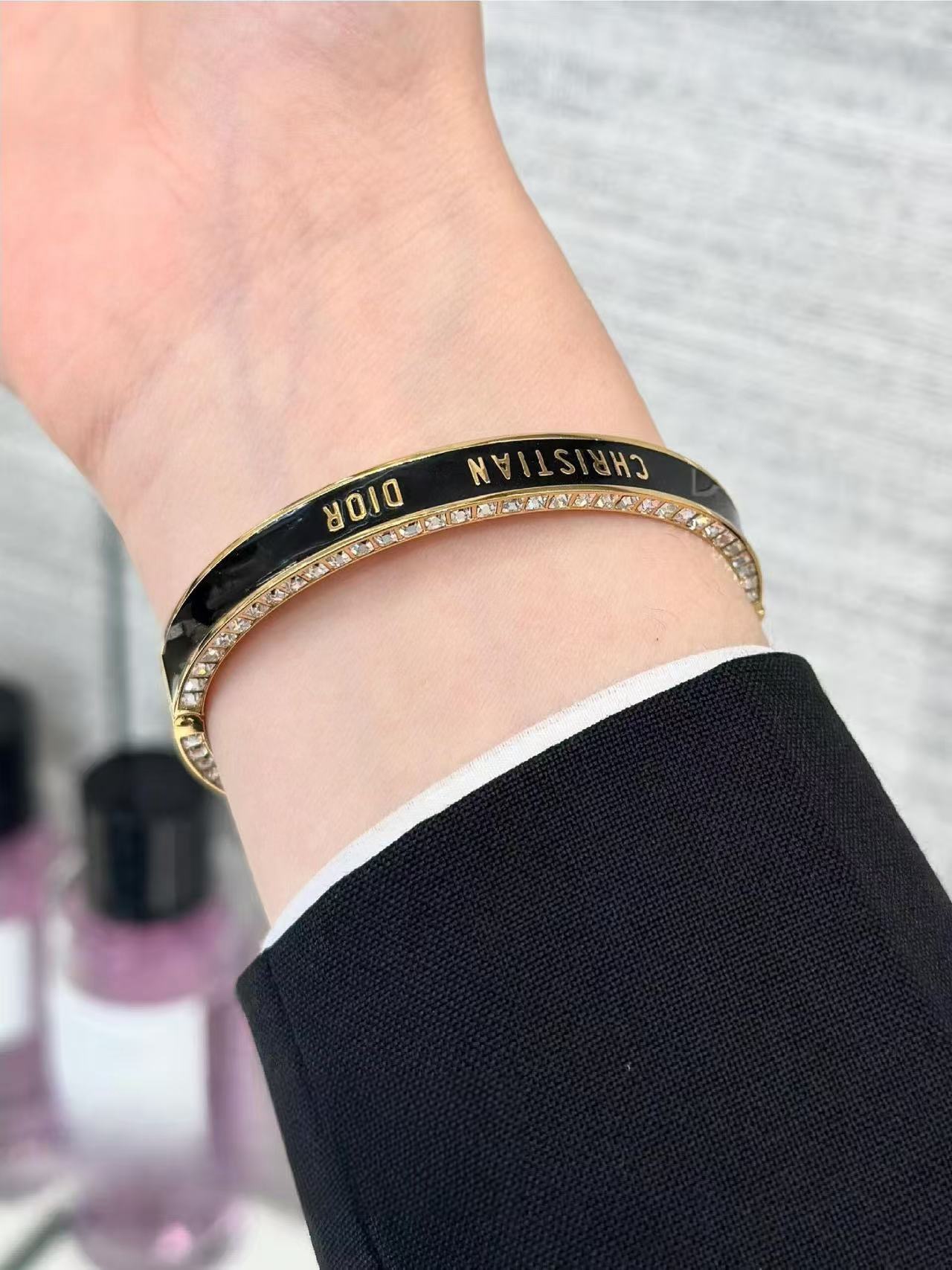 Dior Christian Dior CD New Enamel Crystal Bangle bracelet Gold-tone metal with clear crystals available in black enamel or white enamel with gold lettering 17cm inner circumference