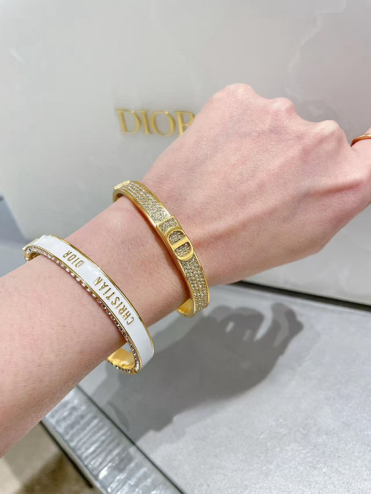 Dior Christian Dior CD New Enamel Crystal Bangle bracelet Gold-tone metal with clear crystals available in black enamel or white enamel with gold lettering 17cm inner circumference