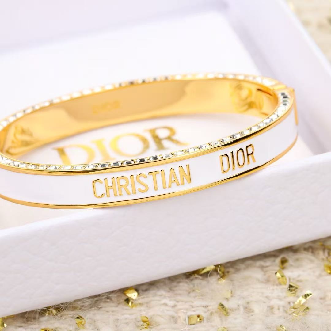 Dior Christian Dior CD New Enamel Crystal Bangle bracelet Gold-tone metal with clear crystals available in black enamel or white enamel with gold lettering 17cm inner circumference