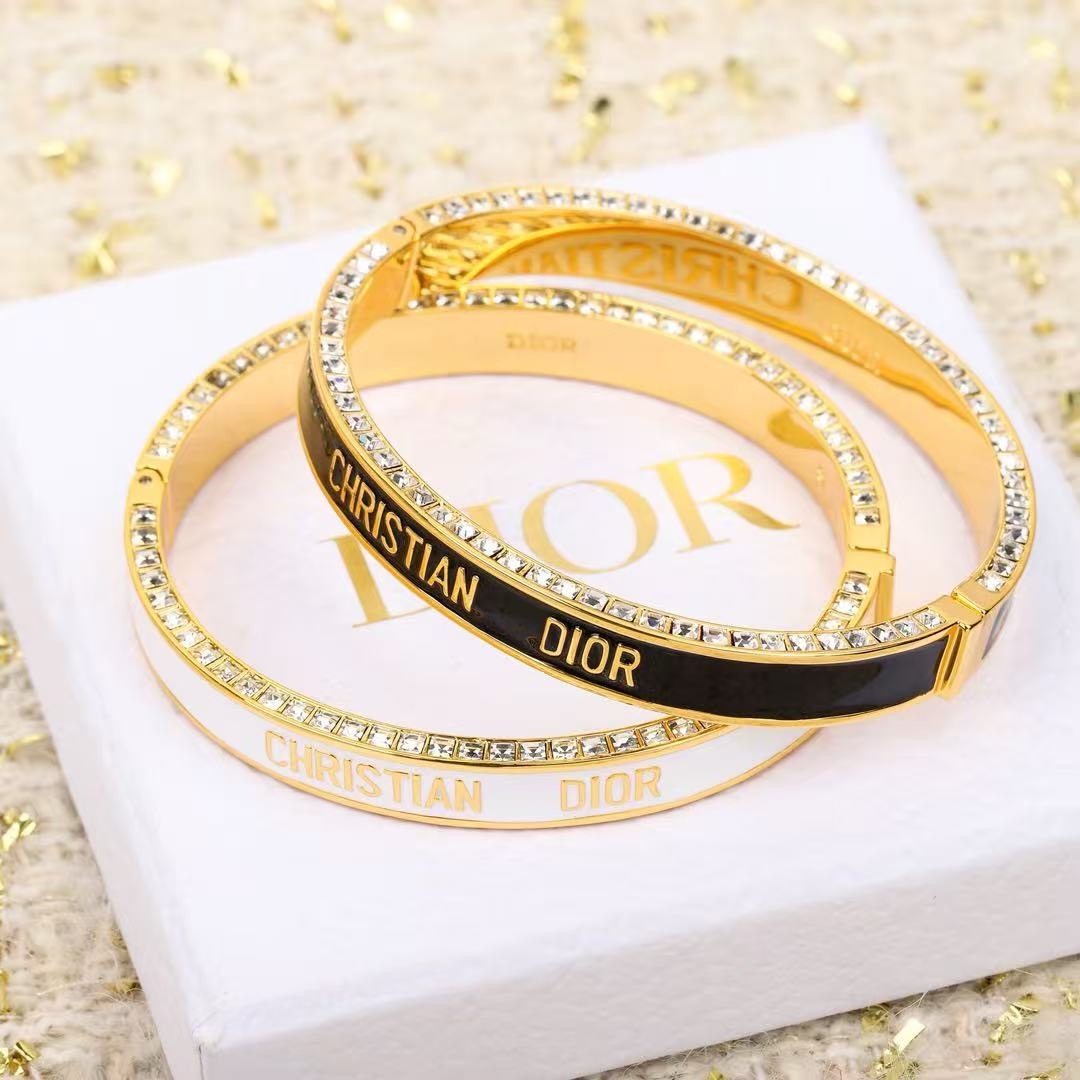 Dior Christian Dior CD New Enamel Crystal Bangle bracelet Gold-tone metal with clear crystals available in black enamel or white enamel with gold lettering 17cm inner circumference