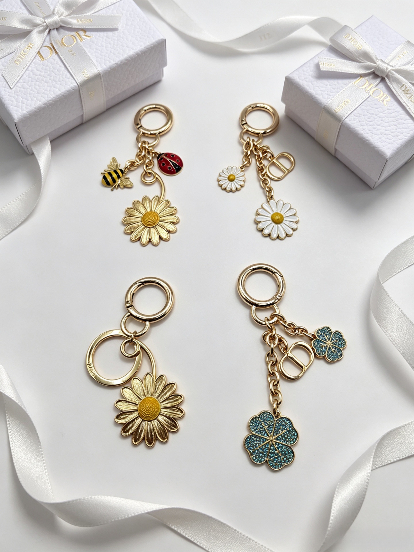 Dior Dior Garden Charms Key Holder pendant Gold-tone metal with yellow and black enamel bee red and black enamel ladybug gold daisy white enamel daisy with yellow center blue glitter four-leaf clover accents Total length 9cm key ring diameter 2 5cm