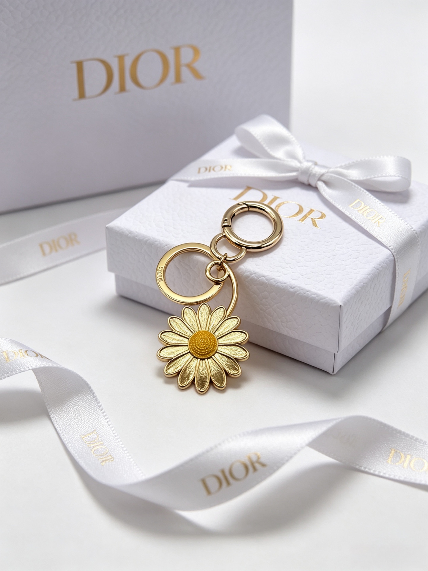 Dior Dior Garden Charms Key Holder pendant Gold-tone metal with yellow and black enamel bee red and black enamel ladybug gold daisy white enamel daisy with yellow center blue glitter four-leaf clover accents Total length 9cm key ring diameter 2 5cm