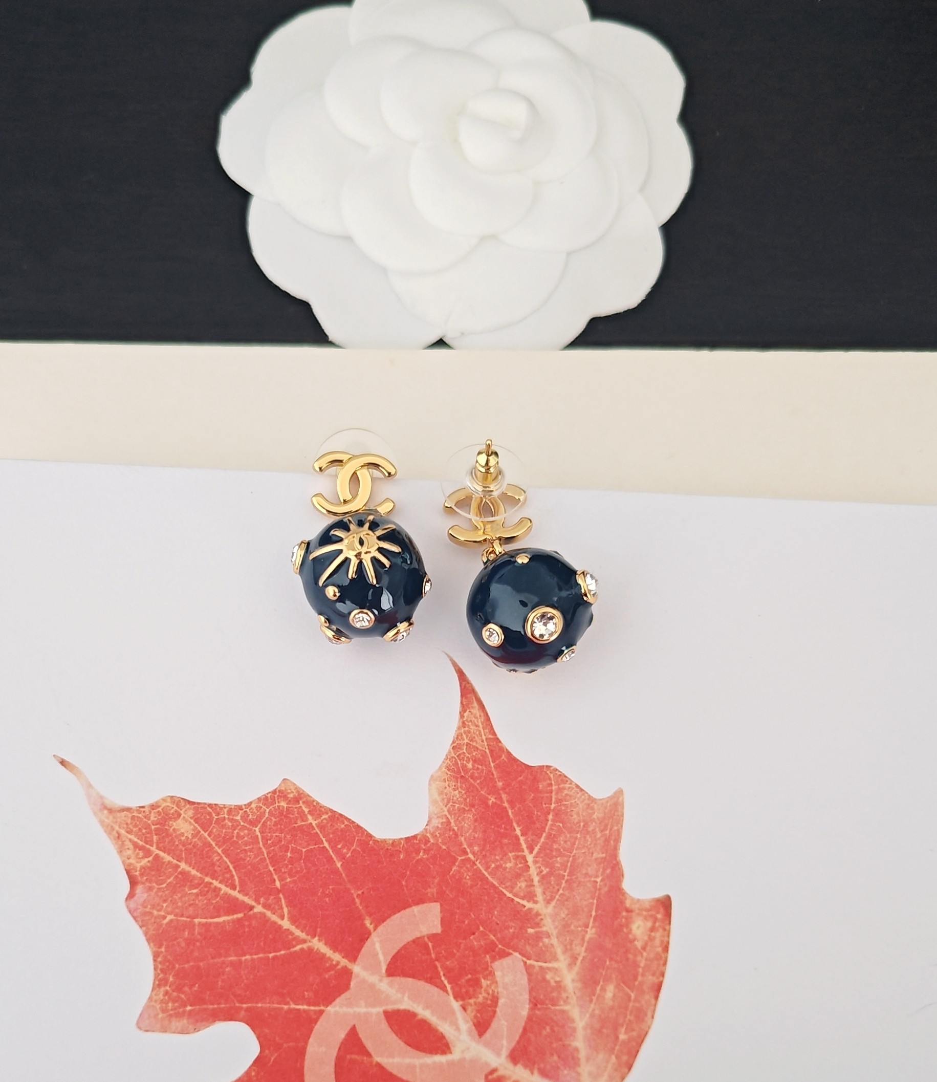 Chanel CC Sun Motif Resin Ball Drop Earrings earrings Gold-tone metal dark navy blue resin clear crystal accents One size drop length approx 2cm
