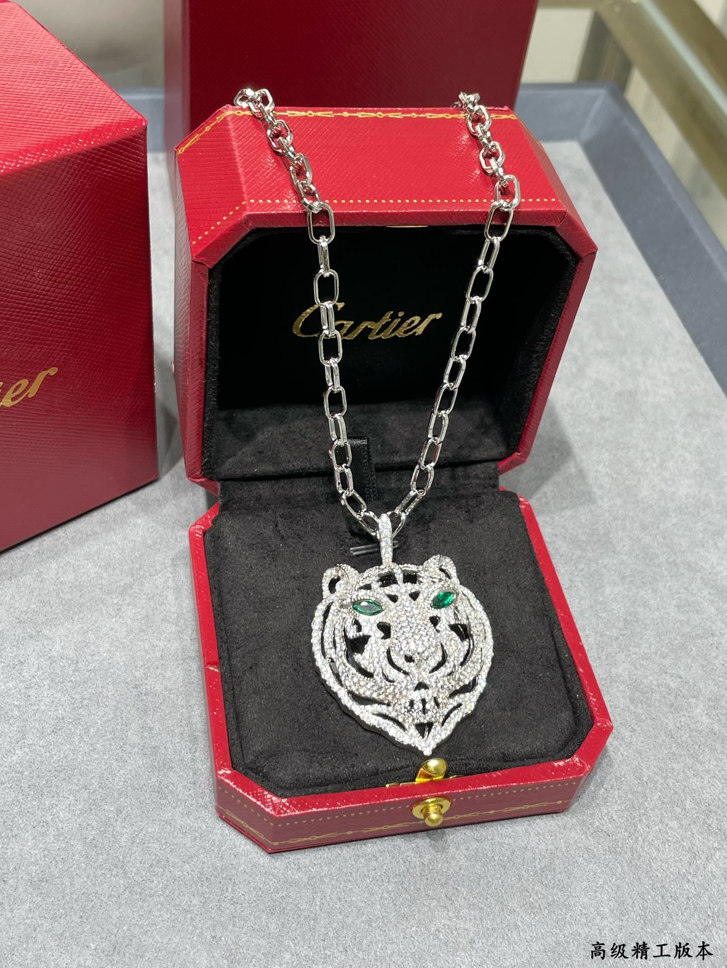 Cartier PANTHERE DE CARTIER Tiger Head Pendant necklace Silver-toned white gold set with white diamonds black onyx accents emerald green gemstone eyes black enamel reverse 80cm