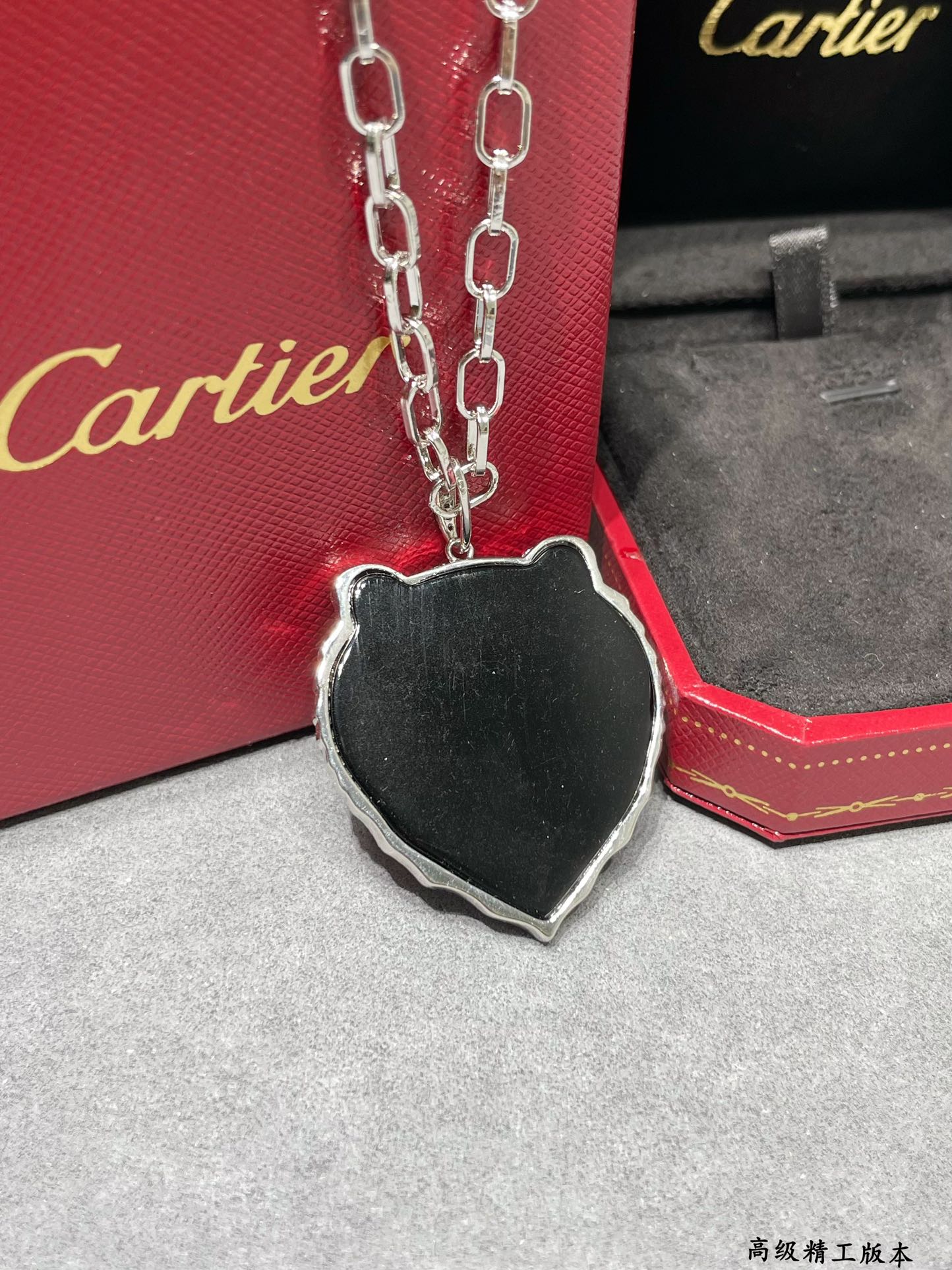 Cartier PANTHERE DE CARTIER Tiger Head Pendant necklace Silver-toned white gold set with white diamonds black onyx accents emerald green gemstone eyes black enamel reverse 80cm