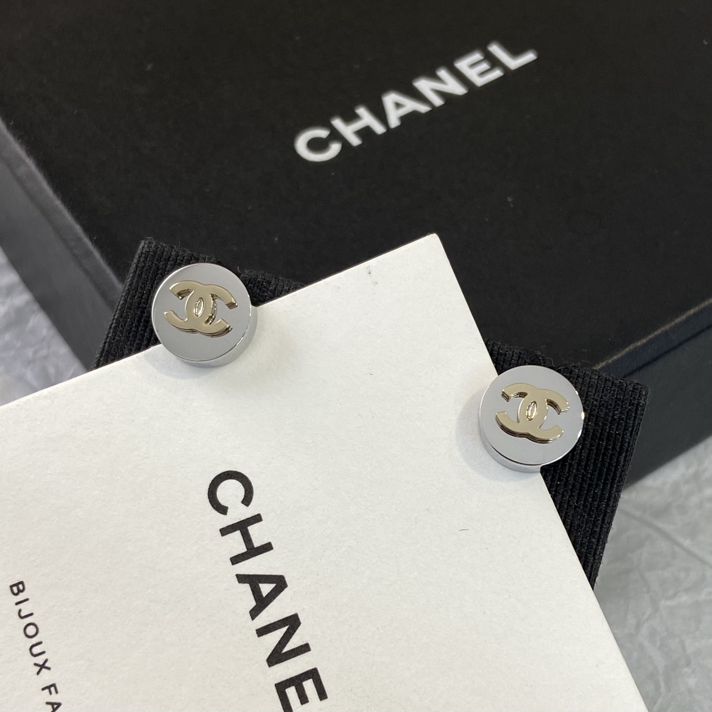 Chanel CC Logo Round Stud Earrings earrings silver-toned metal with gold-toned interlocking CC logo 10mm diameter
