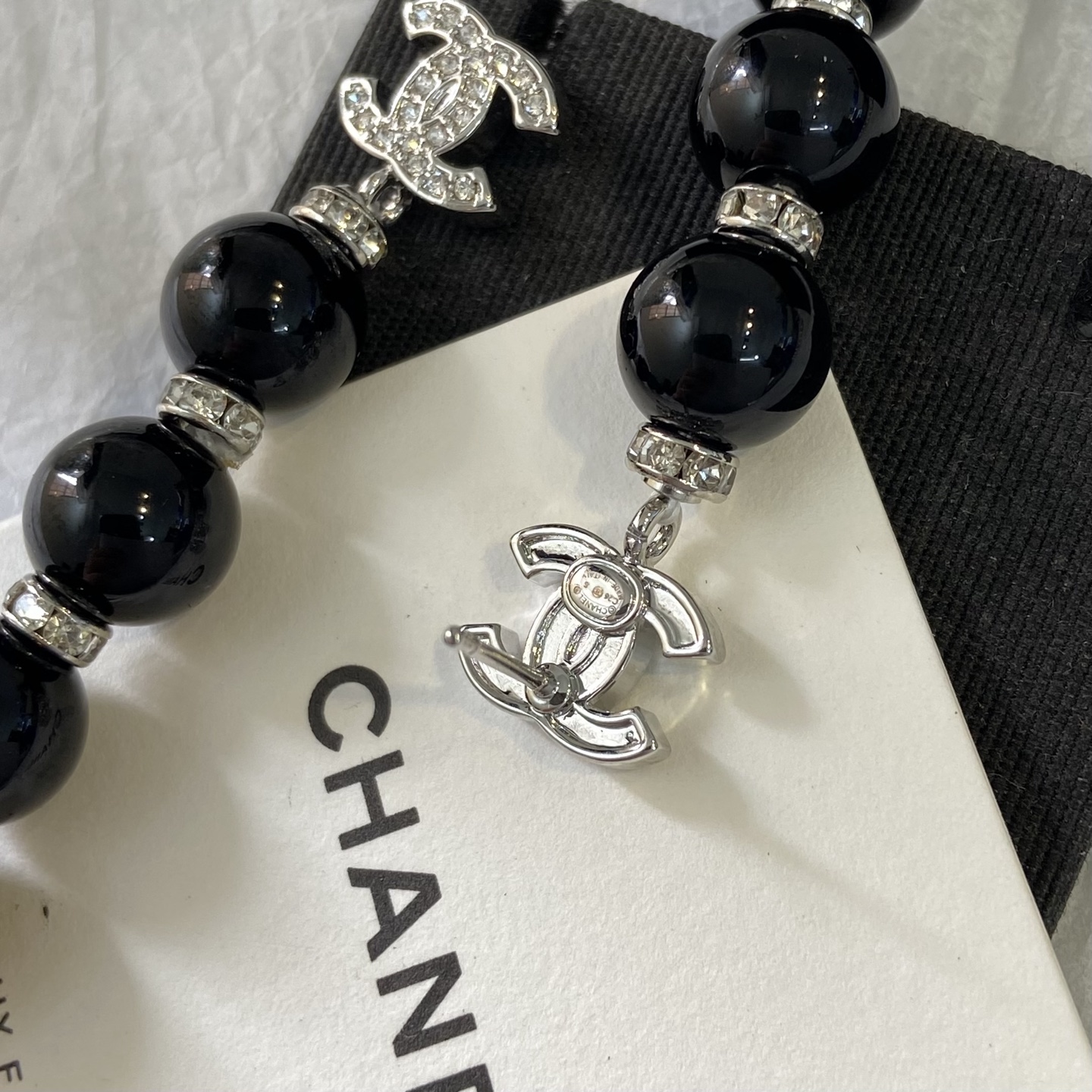 Chanel CC Logo Pearl Drop Earrings earrings Gold-tone metal with clear crystals and cream faux pearls Silver-tone metal with clear crystals and black resin beads 6 5cm length