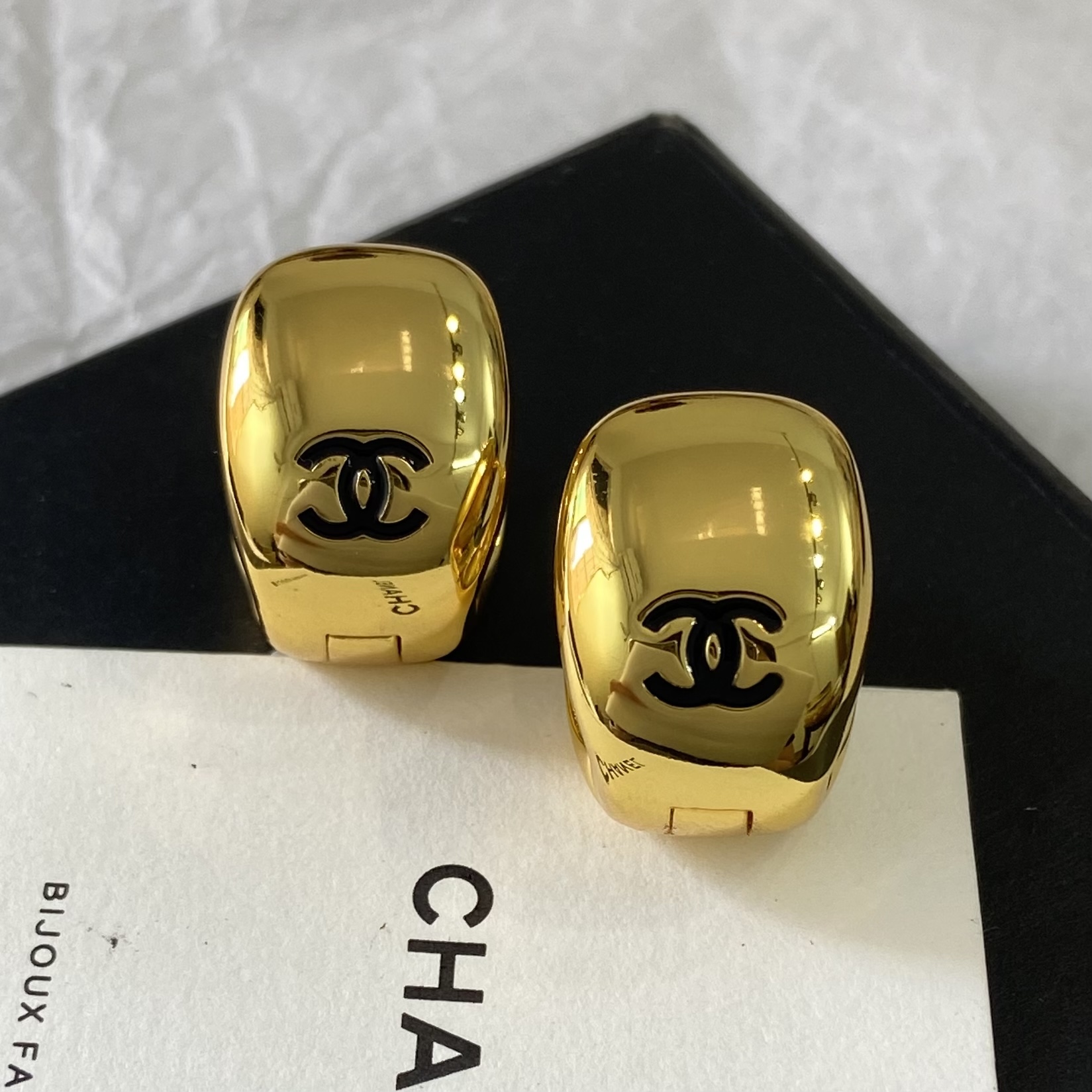 Chanel CC Logo Dome Clip-On Earrings earrings Polished gold-tone metal with black enamel CC logo One Size
