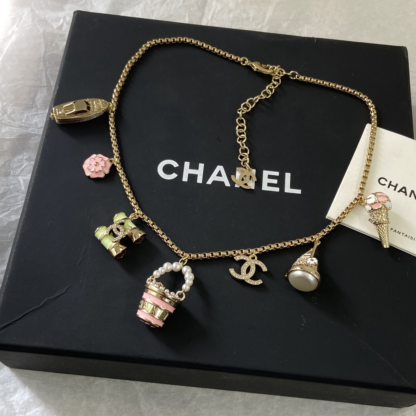 Chanel CC Logo Beach Vacation Charms Collection necklace Gold-tone metal with white faux pearls pink enamel light green enamel clear crystal accents and cream pearl cabochon 42cm with 5cm extender chain