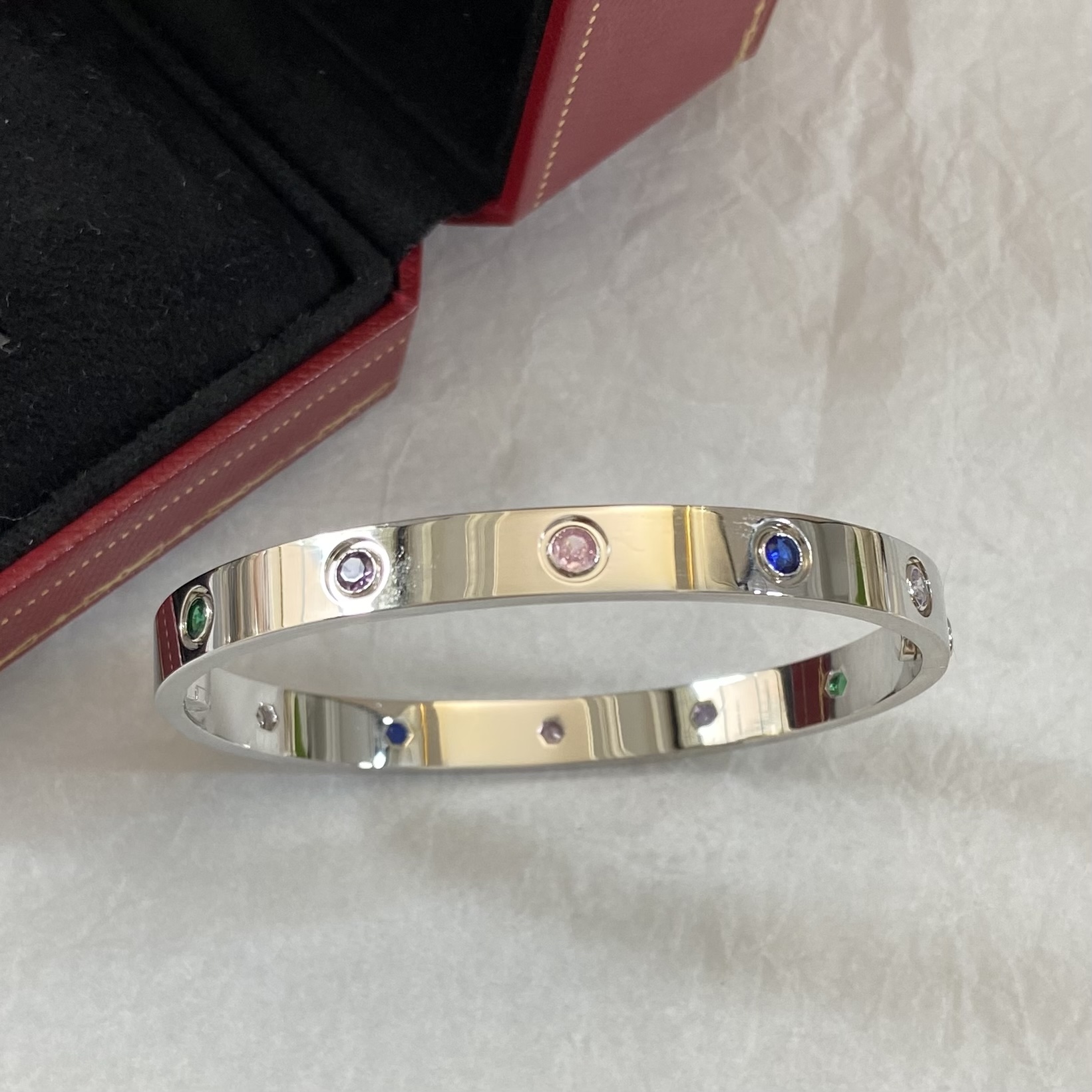 Cartier Love bracelet 18k yellow gold and 18k white gold with multi-color gemstones including pink sapphire blue sapphire green garnet amethyst orange garnet and diamond 17