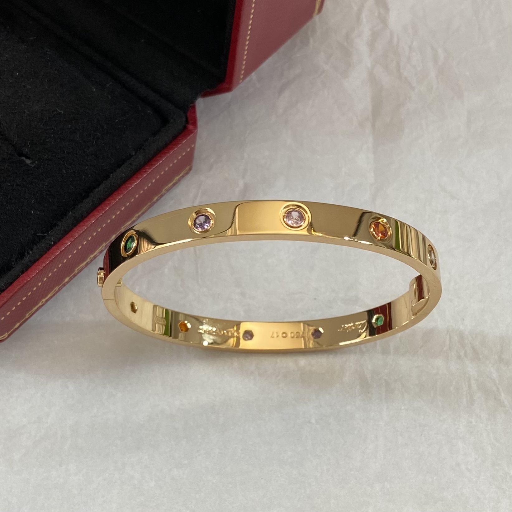 Cartier Love bracelet 18k yellow gold and 18k white gold with multi-color gemstones including pink sapphire blue sapphire green garnet amethyst orange garnet and diamond 17