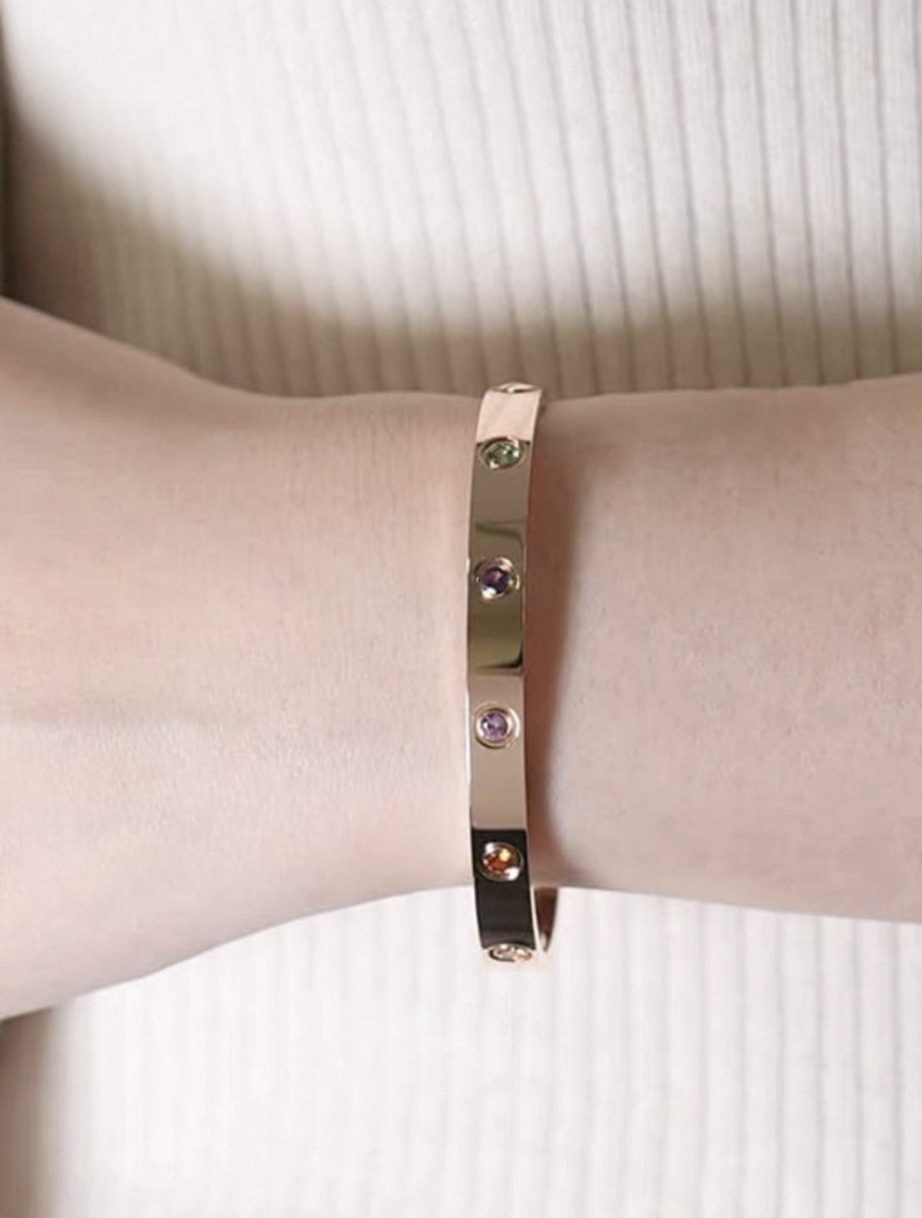 Cartier Love bracelet 18k yellow gold and 18k white gold with multi-color gemstones including pink sapphire blue sapphire green garnet amethyst orange garnet and diamond 17