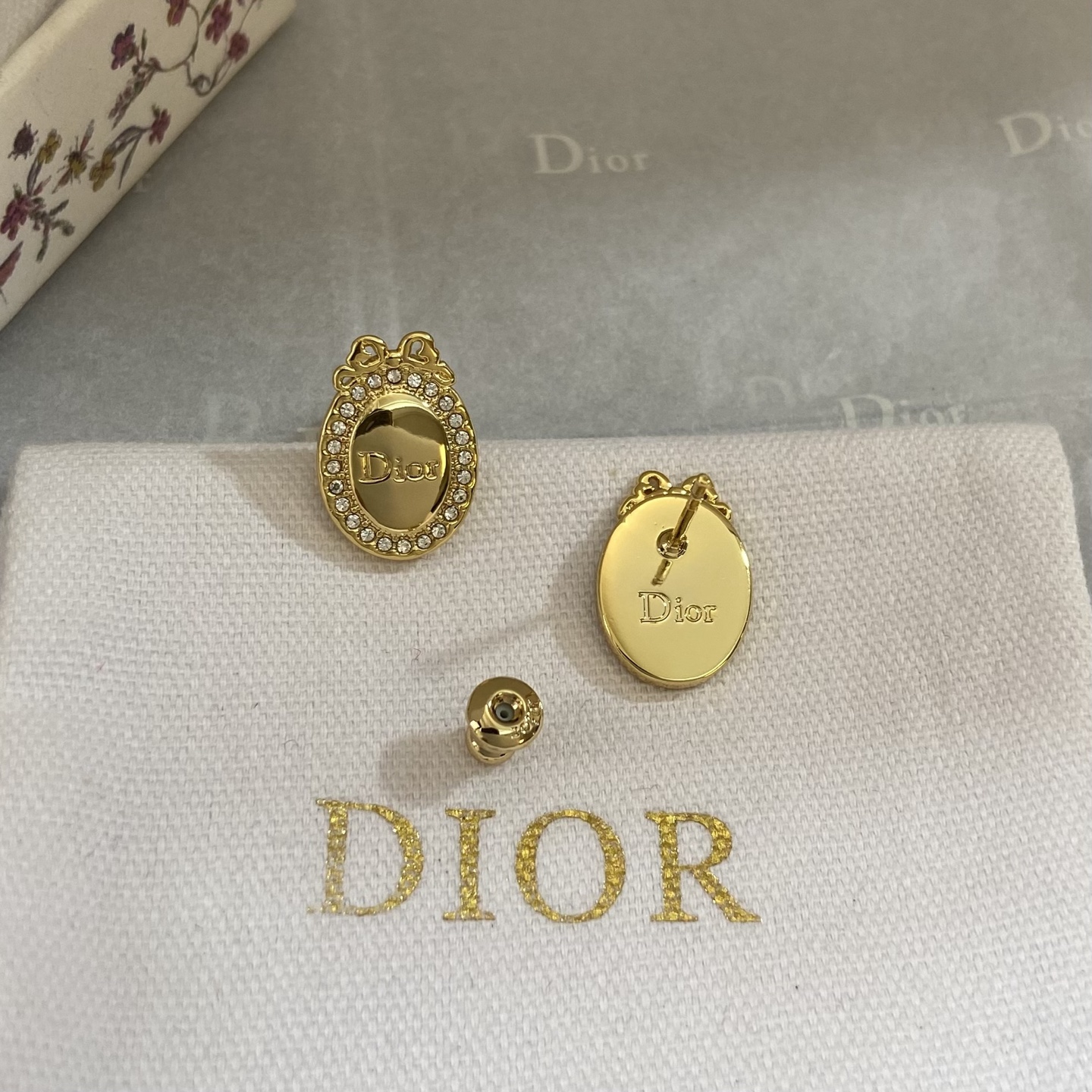 Dior Oval Logo Bow Crystal Stud Earrings earrings gold-tone metal with clear crystal accents 1 5cm length
