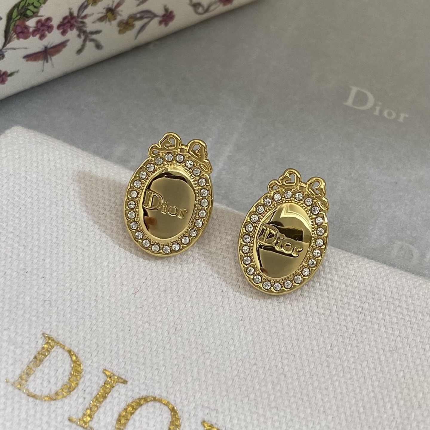 Dior Oval Logo Bow Crystal Stud Earrings earrings gold-tone metal with clear crystal accents 1 5cm length