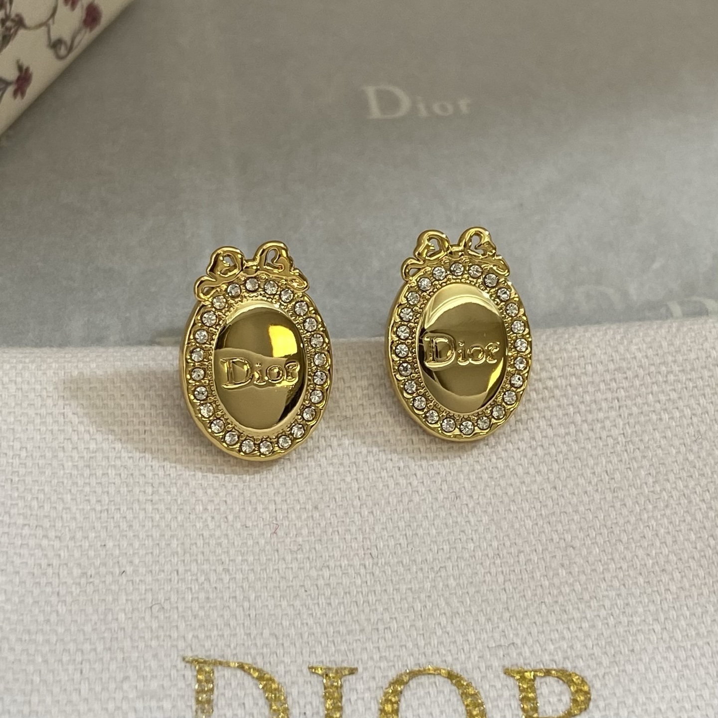 Dior Oval Logo Bow Crystal Stud Earrings earrings gold-tone metal with clear crystal accents 1 5cm length