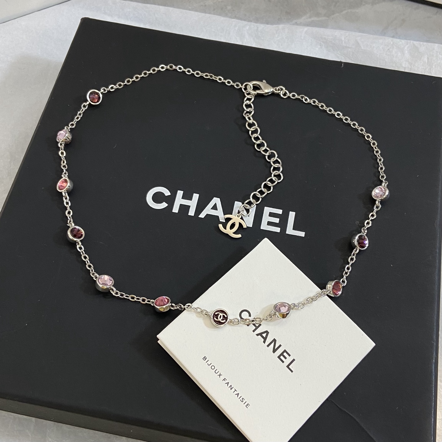 Chanel CC Logo Multicolor Crystal Station Necklace necklace Silver-toned metal with light pink fuchsia pink and burgundy crystal accents light gold-tone CC charm 42cm with 5cm extender