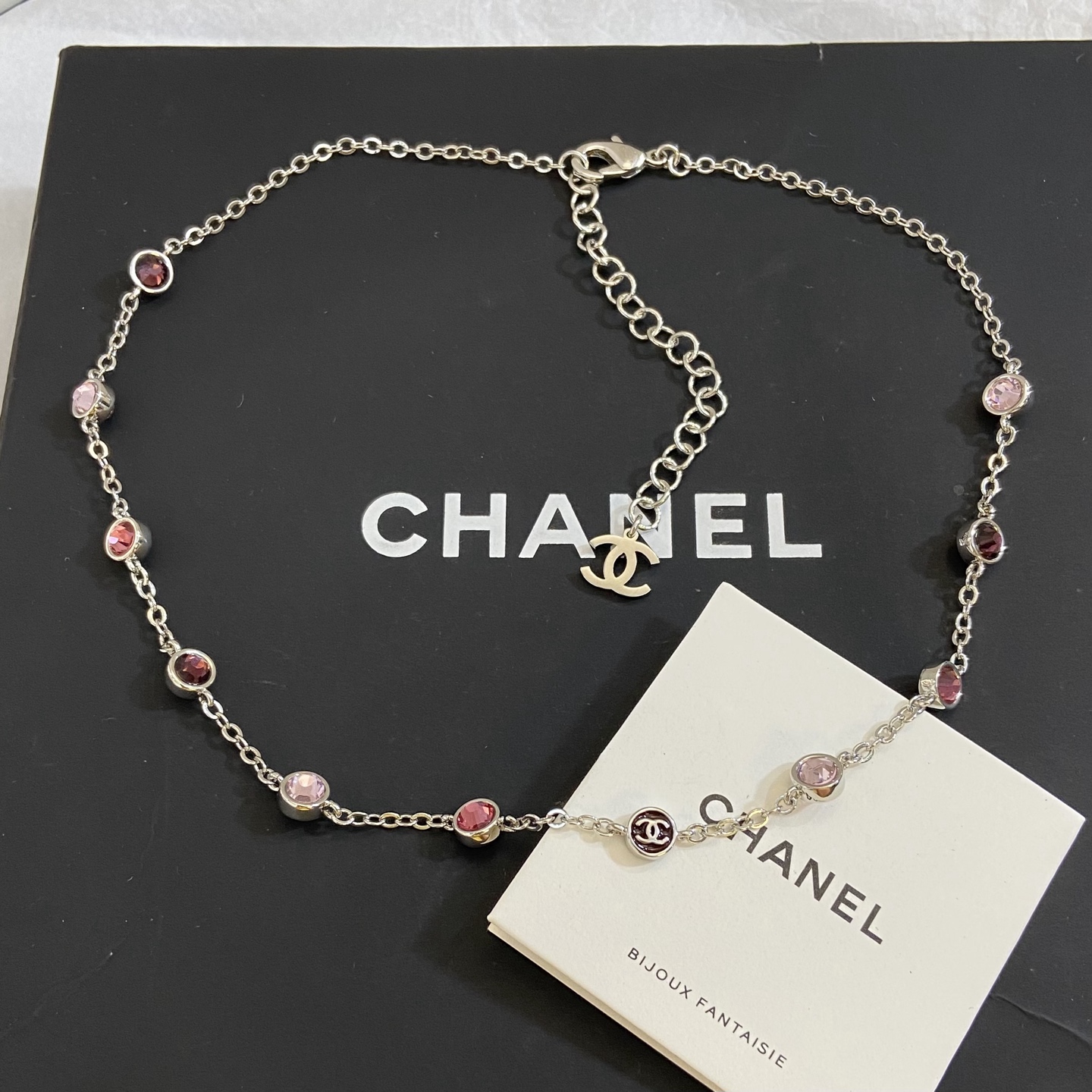 Chanel CC Logo Multicolor Crystal Station Necklace necklace Silver-toned metal with light pink fuchsia pink and burgundy crystal accents light gold-tone CC charm 42cm with 5cm extender