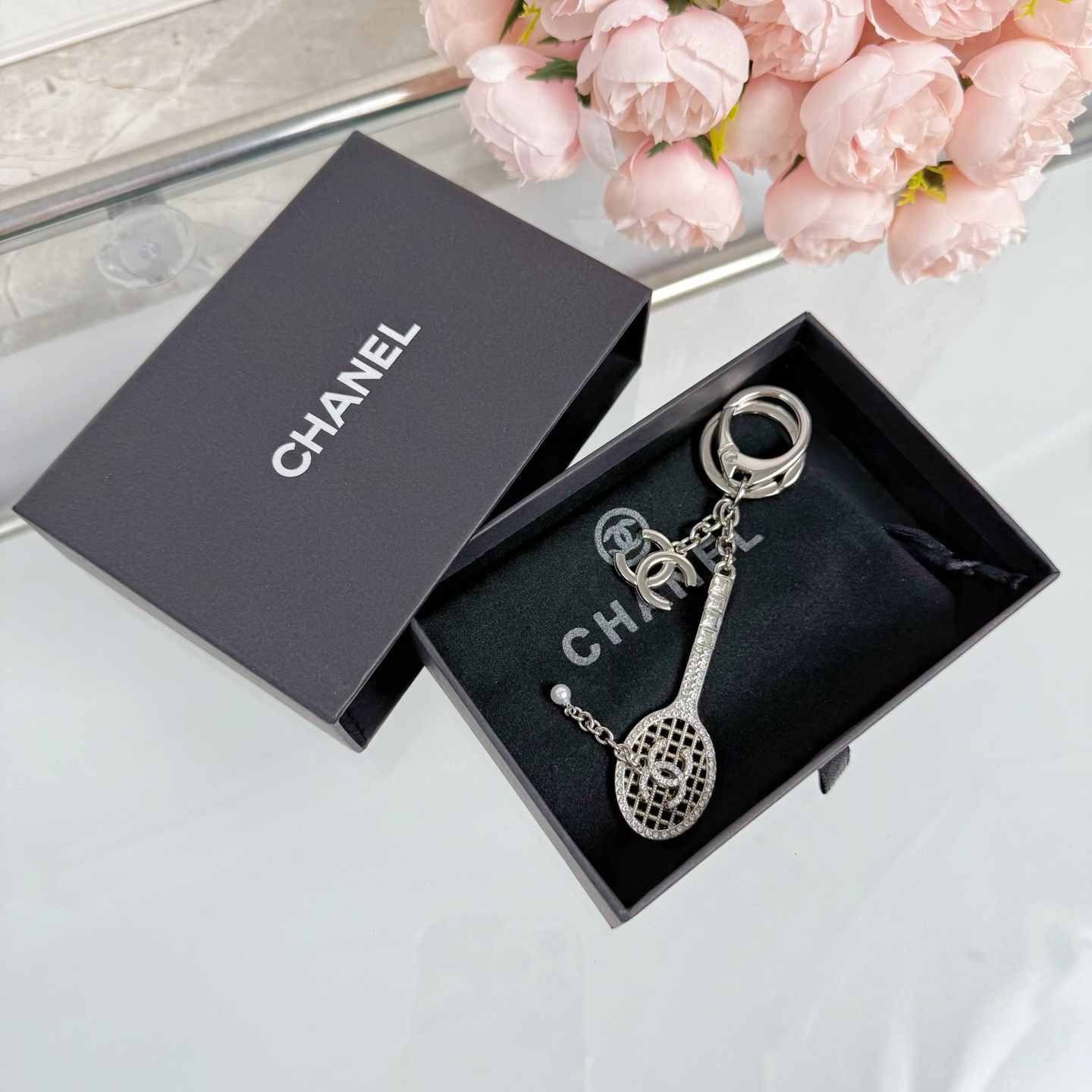 Chanel CC Tennis Racket Bag Charm Keychain pendant Gold-tone metal with clear crystals and white faux pearl Silver-tone metal with clear crystals and white faux pearl 10cm total length
