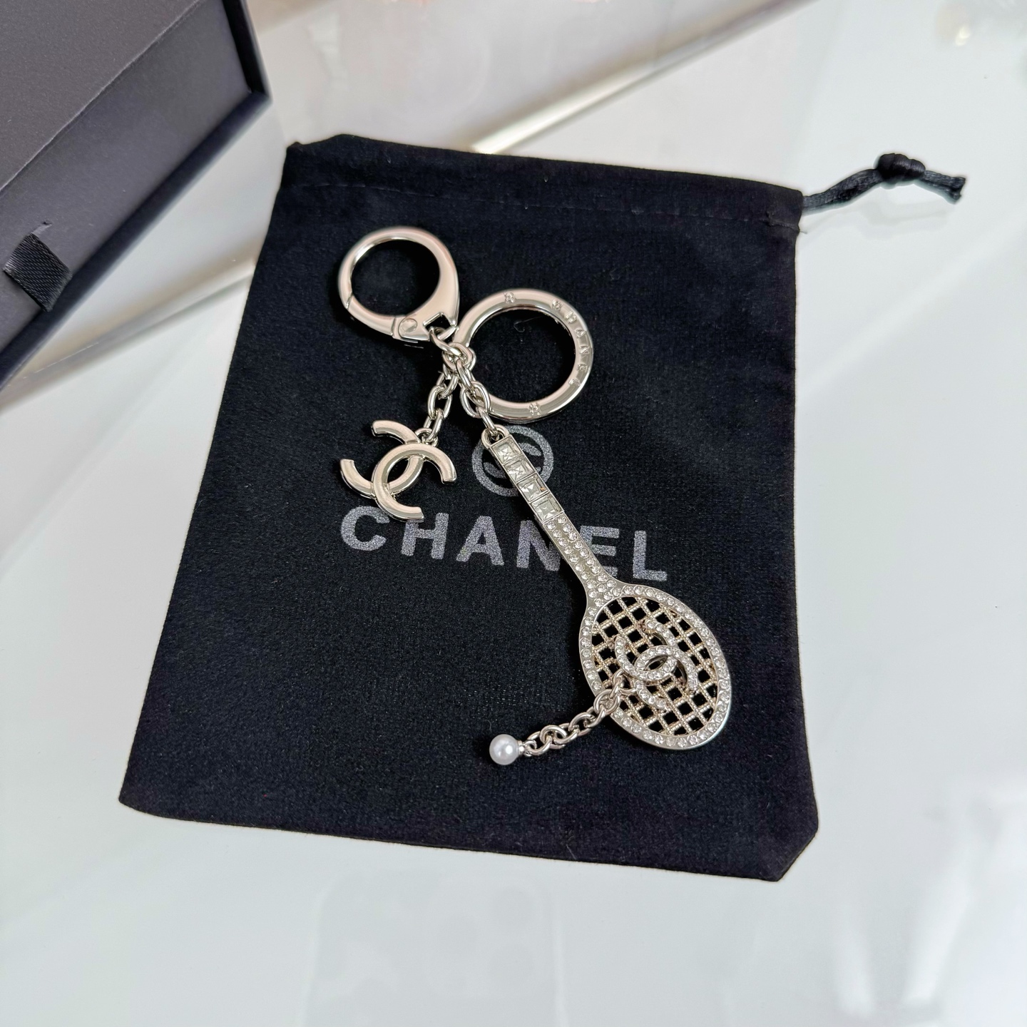 Chanel CC Tennis Racket Bag Charm Keychain pendant Gold-tone metal with clear crystals and white faux pearl Silver-tone metal with clear crystals and white faux pearl 10cm total length