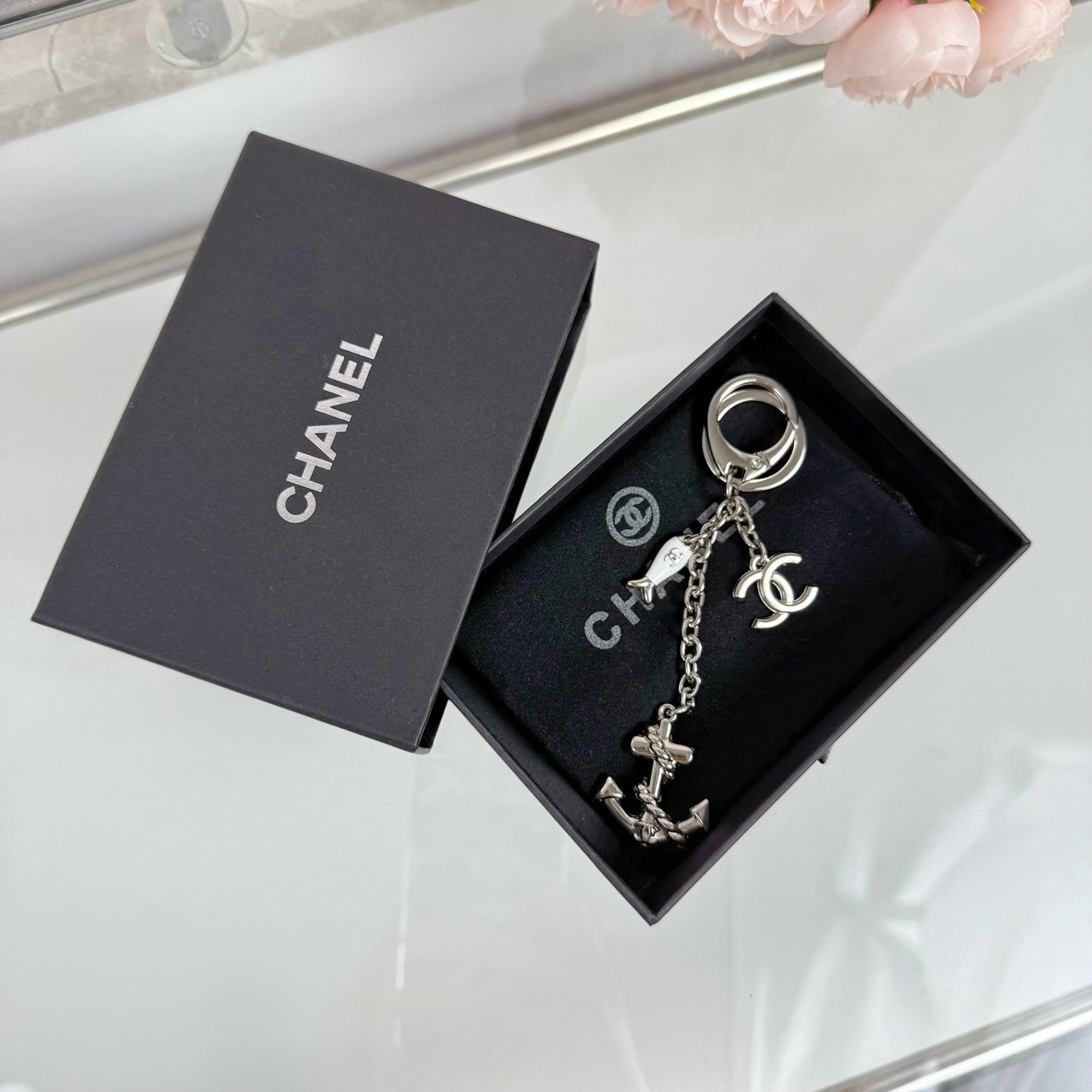 Chanel CC Nautical Anchor Fish Charm Key Holder pendant Gold-tone metal with white enamel fish charm Silver-tone metal with white enamel fish charm 10cm total drop length