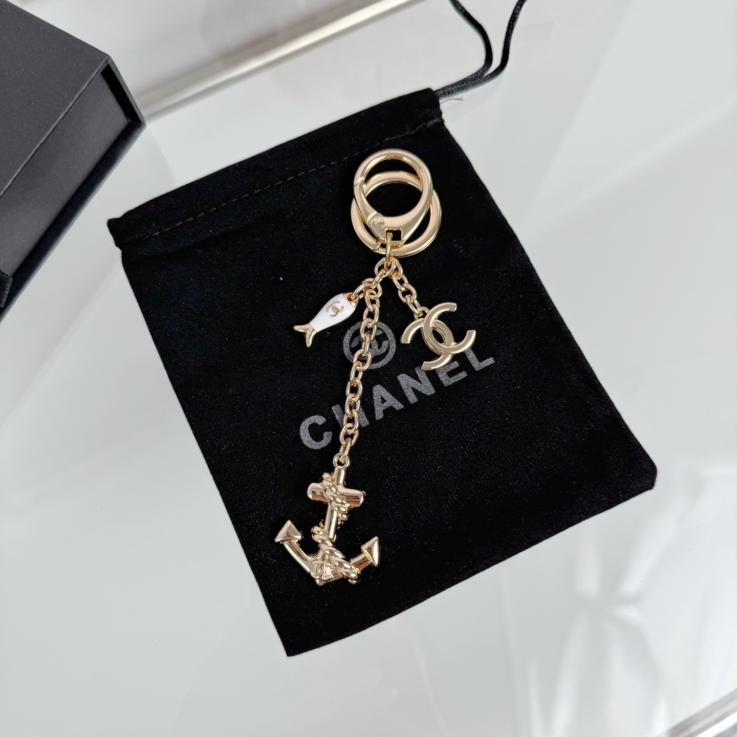 Chanel CC Nautical Anchor Fish Charm Key Holder pendant Gold-tone metal with white enamel fish charm Silver-tone metal with white enamel fish charm 10cm total drop length