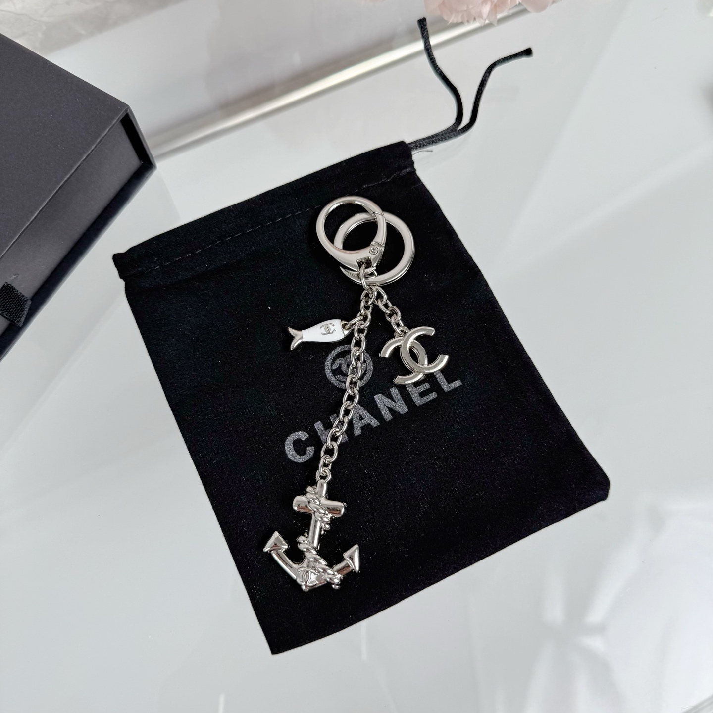 Chanel CC Nautical Anchor Fish Charm Key Holder pendant Gold-tone metal with white enamel fish charm Silver-tone metal with white enamel fish charm 10cm total drop length