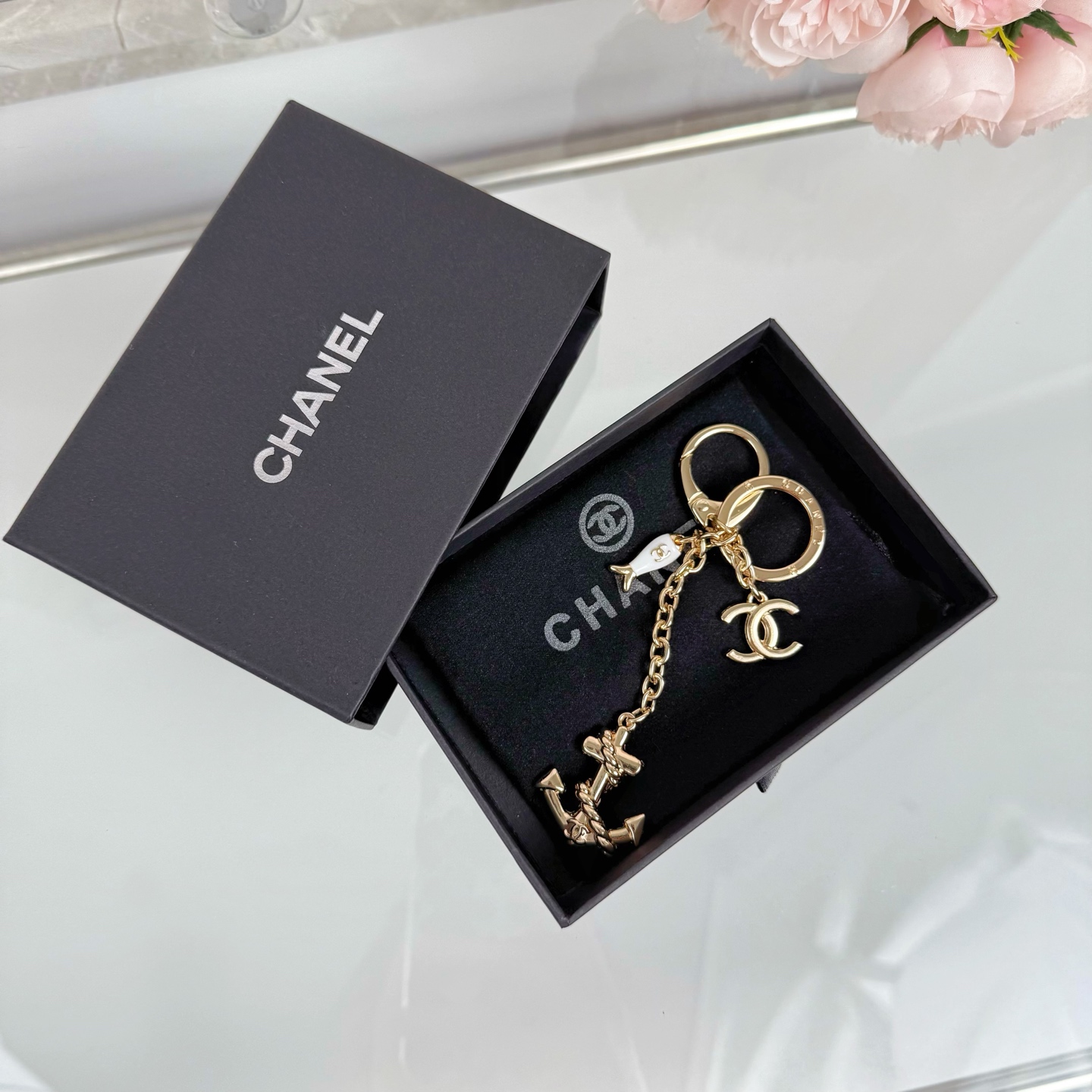 Chanel CC Nautical Anchor Fish Charm Key Holder pendant Gold-tone metal with white enamel fish charm Silver-tone metal with white enamel fish charm 10cm total drop length