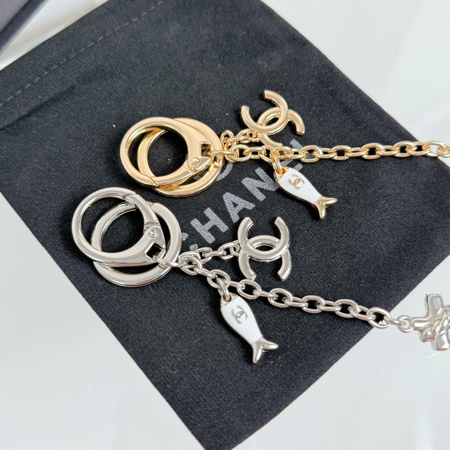 Chanel CC Nautical Anchor Fish Charm Key Holder pendant Gold-tone metal with white enamel fish charm Silver-tone metal with white enamel fish charm 10cm total drop length