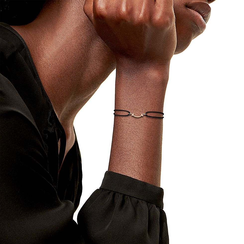 Tiffany Co T Smile bracelet available in yellow gold rose gold silver metal finishes with red black or Tiffany blue cord adjustable sliding knot cord fits 15-20cm wrist