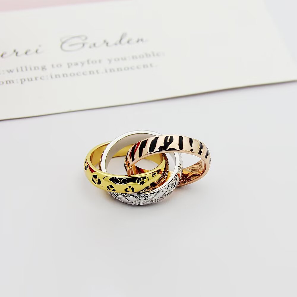 Cartier TRINITY ring 18k yellow gold with black leopard print lacquer 18k rose gold with black tiger stripe lacquer 18k white gold with diamond-set snake scale pattern 7