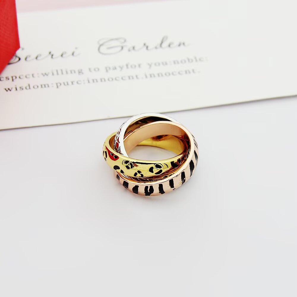 Cartier TRINITY ring 18k yellow gold with black leopard print lacquer 18k rose gold with black tiger stripe lacquer 18k white gold with diamond-set snake scale pattern 7