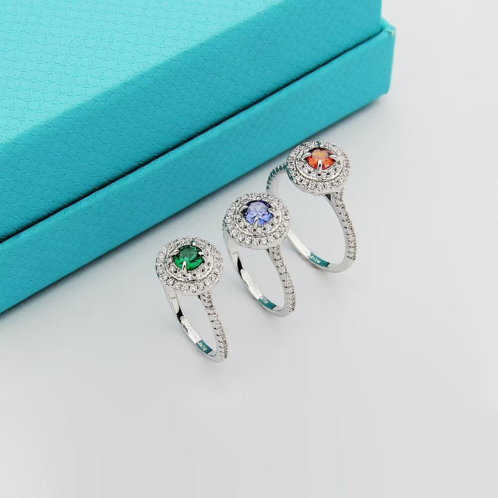 Tiffany Tiffany Soleste ring silver-toned white metal with white diamond accents and colored center stones emerald green ruby red tanzanite purple orange garnet 7