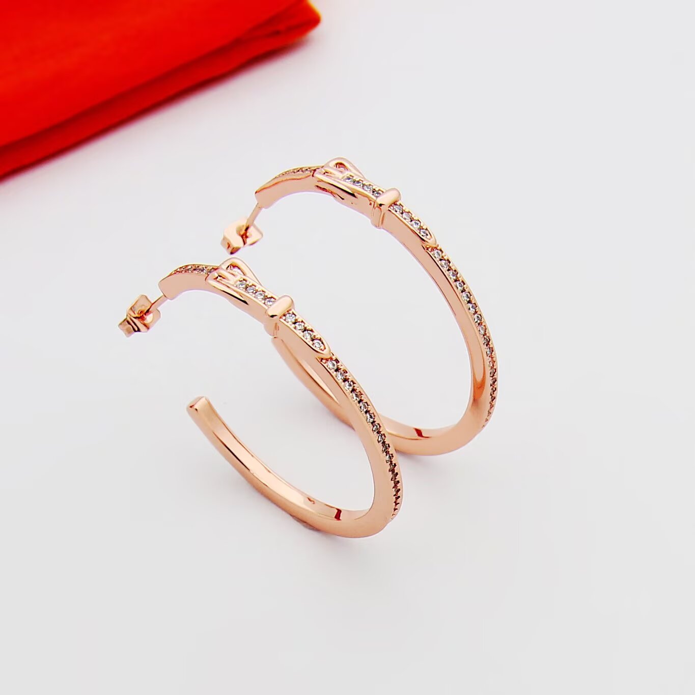 Hermes Buckle Hoop earrings Available in rose gold silver yellow gold metal tones with clear diamond-like accent stones 30mm diameter