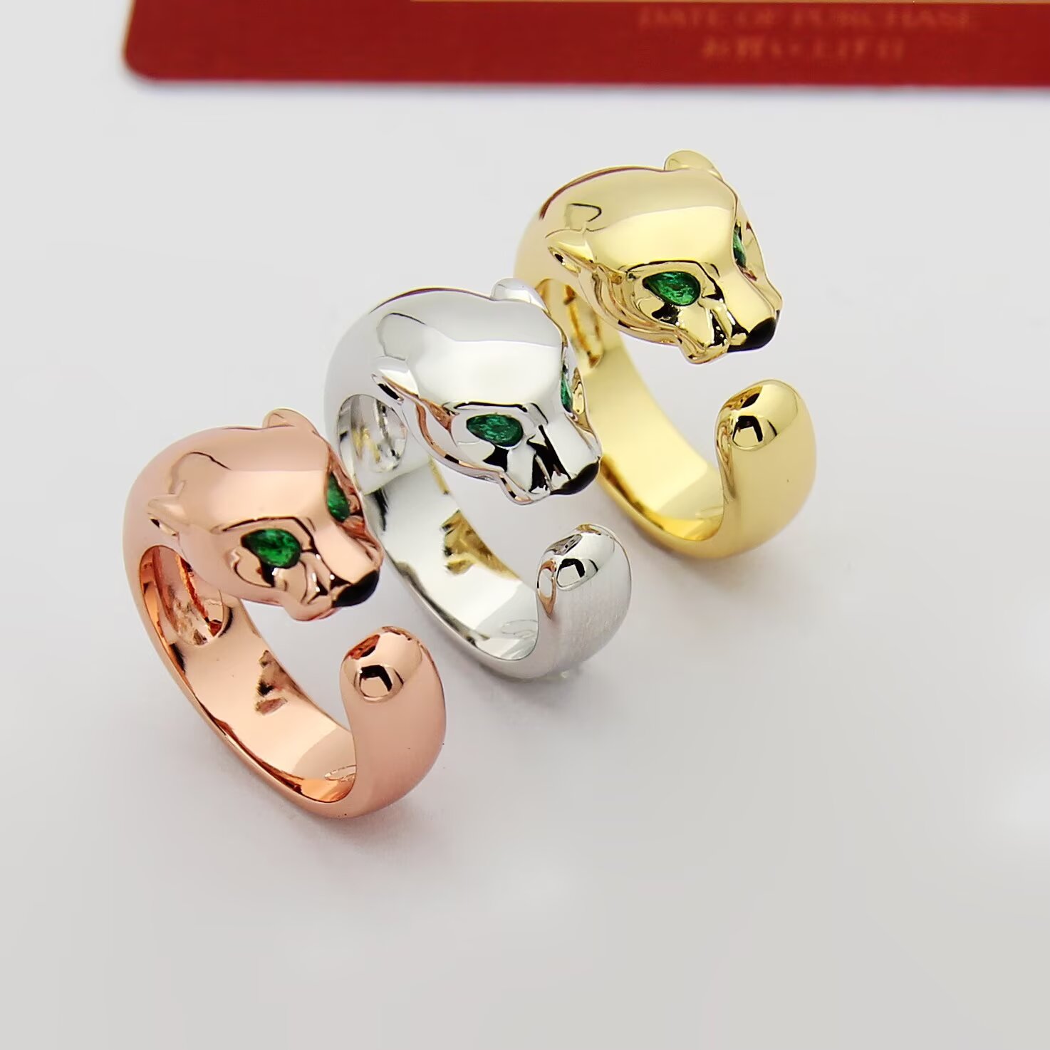 Cartier Panthere de Cartier ring 18k rose gold 18k white gold 18k yellow gold with green tsavorite garnet eyes and black onyx nose accents adjustable open band