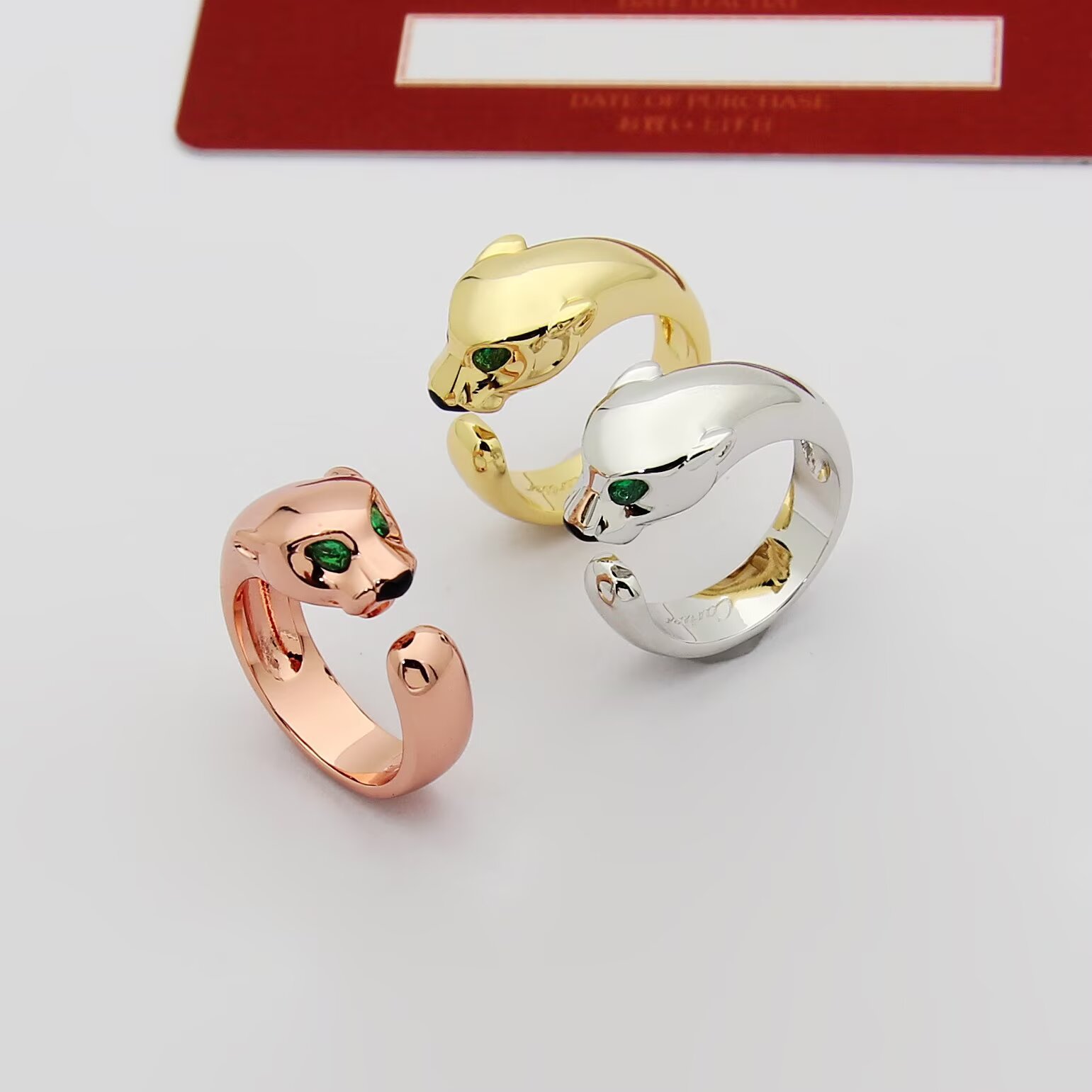 Cartier Panthere de Cartier ring 18k rose gold 18k white gold 18k yellow gold with green tsavorite garnet eyes and black onyx nose accents adjustable open band