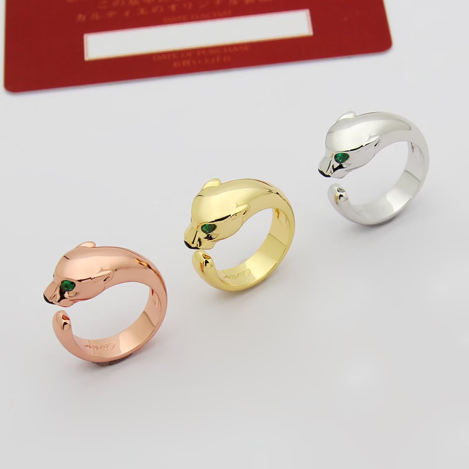 Cartier Panthere de Cartier ring 18k rose gold 18k white gold 18k yellow gold with green tsavorite garnet eyes and black onyx nose accents adjustable open band