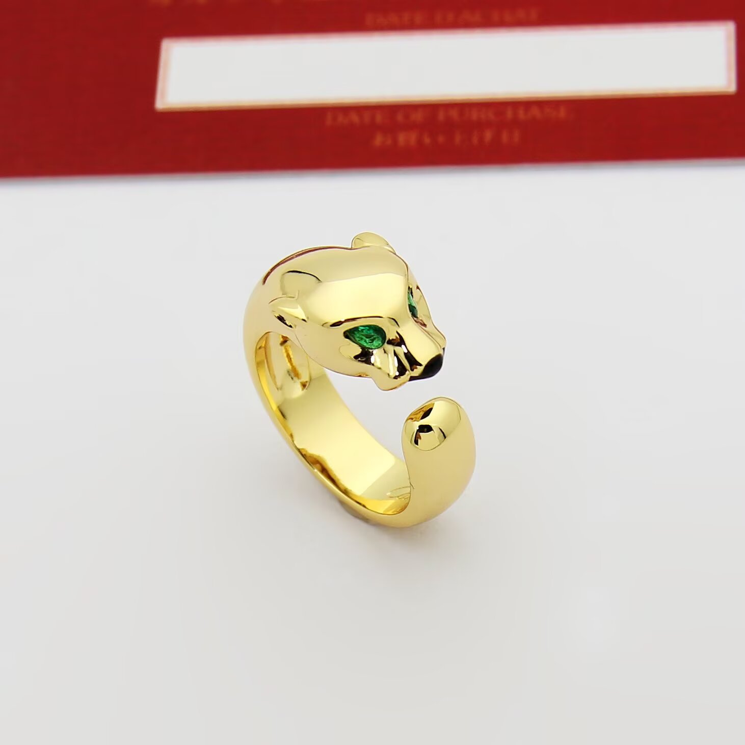 Cartier Panthere de Cartier ring 18k rose gold 18k white gold 18k yellow gold with green tsavorite garnet eyes and black onyx nose accents adjustable open band