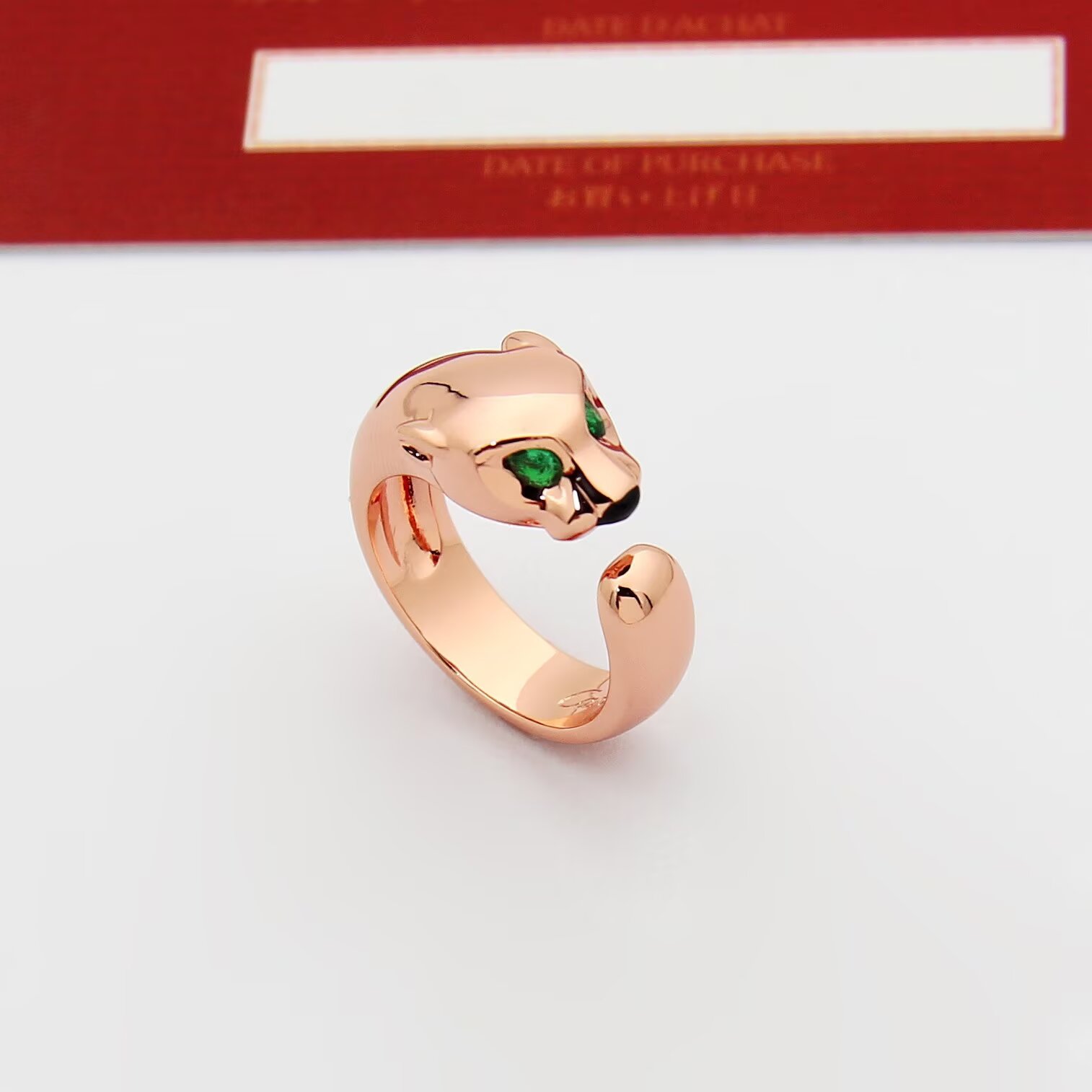 Cartier Panthere de Cartier ring 18k rose gold 18k white gold 18k yellow gold with green tsavorite garnet eyes and black onyx nose accents adjustable open band