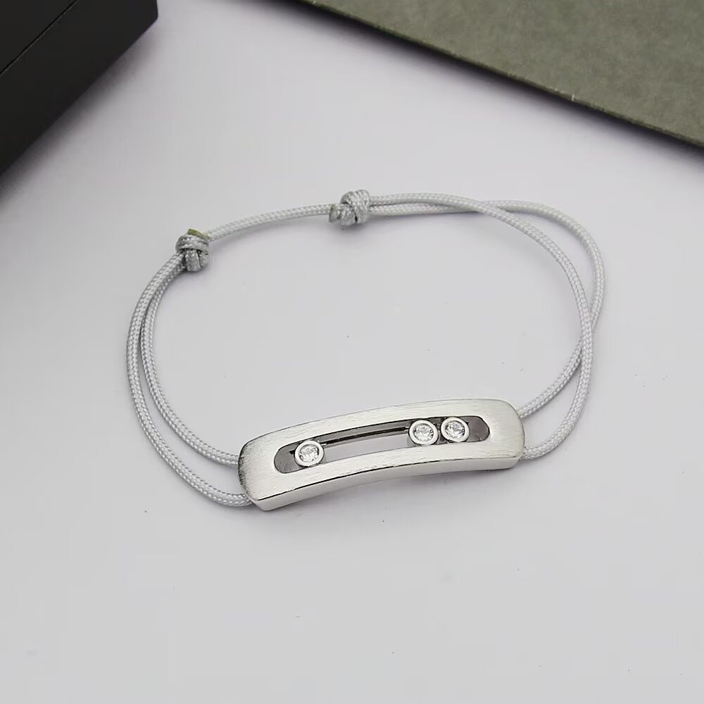 Messika Move Titanium Romain Grosjean Men s Collection bracelet brushed titanium gray metal clear white diamonds gray black navy blue cord options adjustable sliding knot