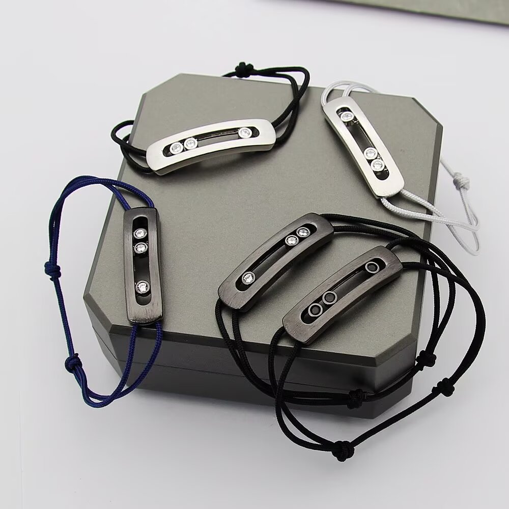 Messika Move Titanium Romain Grosjean Men s Collection bracelet brushed titanium gray metal clear white diamonds gray black navy blue cord options adjustable sliding knot