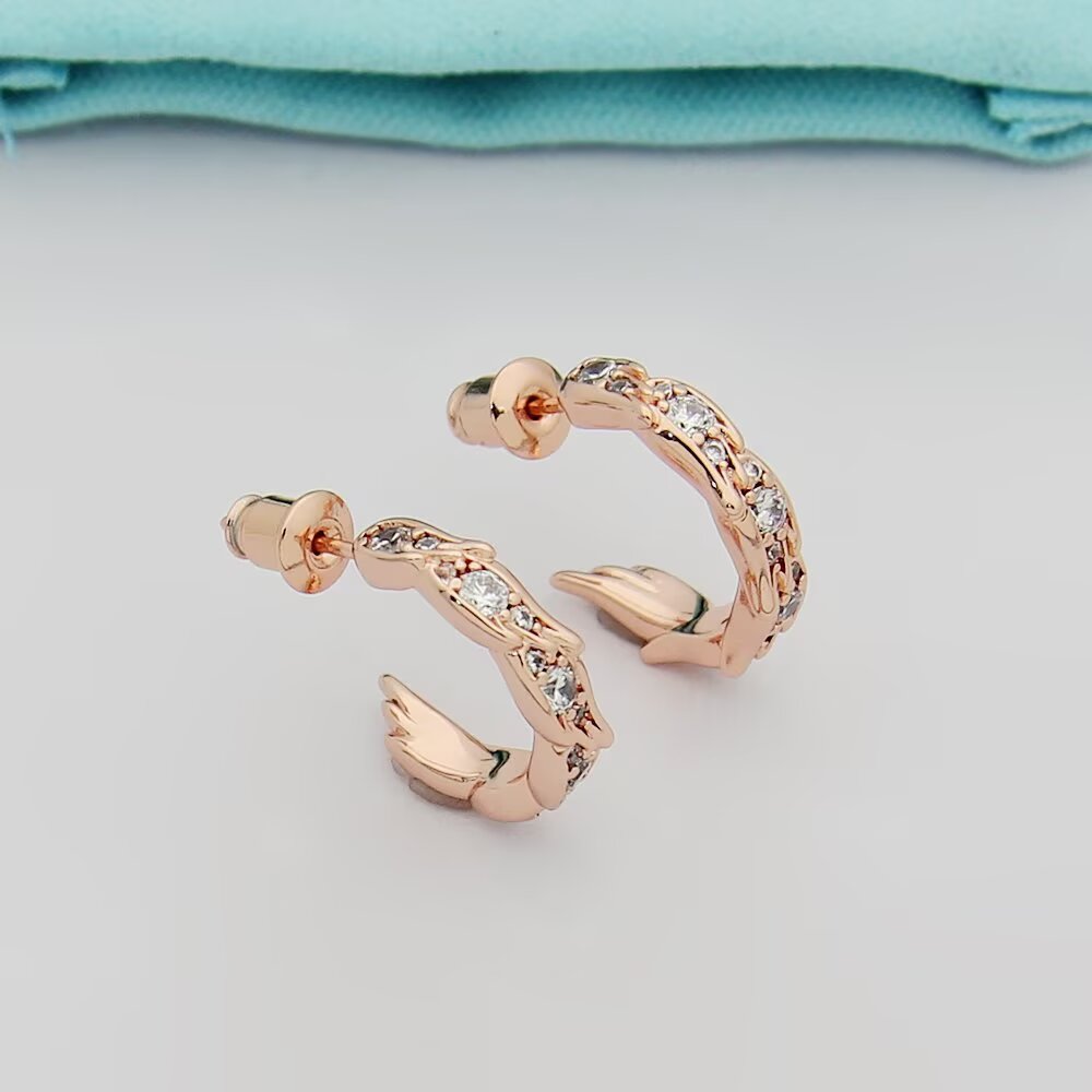 Tiffany Tiffany Victoria Vine Hoop Earrings earrings Available in 18k yellow gold 18k rose gold and sterling silver with round brilliant diamond accents 15mm hoop diameter
