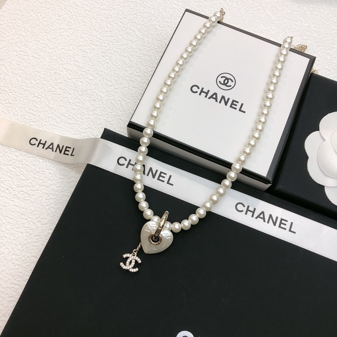 Chanel CC Heart Pearl Pendant Necklace necklace Gold-tone metal white faux pearl clear crystal white mother-of-pearl effect heart charm 40cm with 7cm extender chain